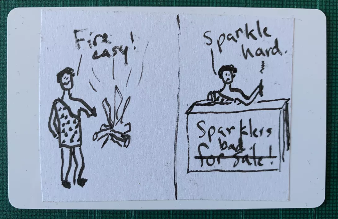 A two-panel comic of a caveman. In the first, he brags that making fire is easy. In the second he laments that making sparklers is hard. He speaks in a caveman style: Fire easy. Sparkle hard.